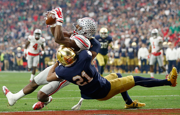 GLENDALE AZ- JANUARY 01 Wide receiver Michael Thomas #3 of the Ohio State Buckeyes catches a touchdown over cornerback Nick Watkins #21 of the Notre Dame Fighting Irish during the first quarter of the Battle Frog Fiesta Bowl at University of Phoenix Sta