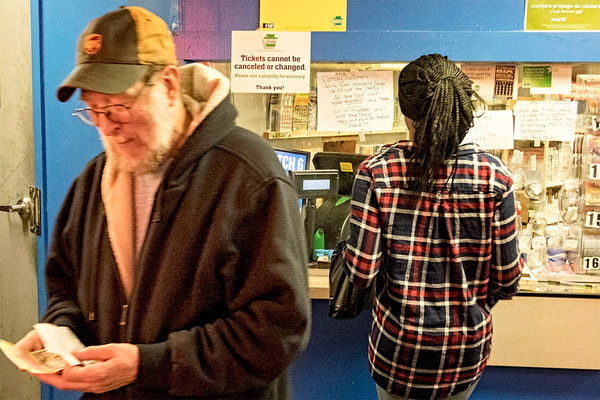 Lawrence Legg of Delaware County checks his tickets after buying them at Terminal Pub Check Cashing at the 69th Street Terminal