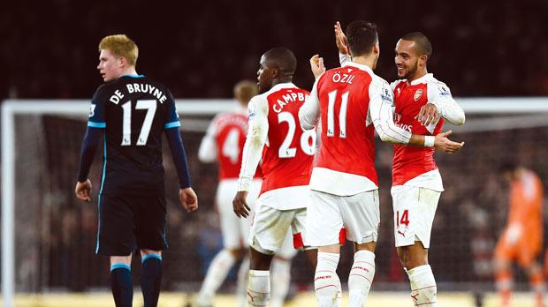 Arsenal players celebrate after Theo Walcott put the Gunners ahead against Man. City