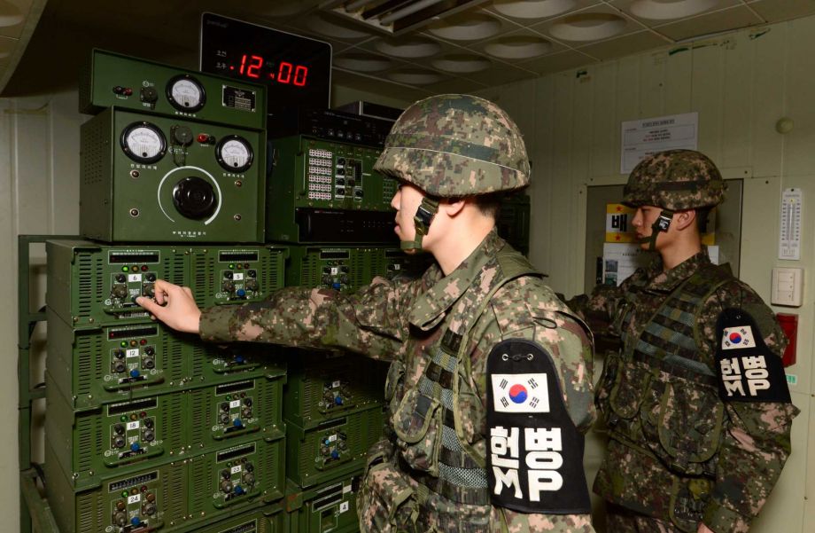 South Korean soldiers stand in front of equipment used for propaganda broadcasts near the border area between South Korea and North Korea in Yeoncheon South Korea Friday Jan. 8 2016. South Korea responded to North Korea's nuclear test with broadcasts