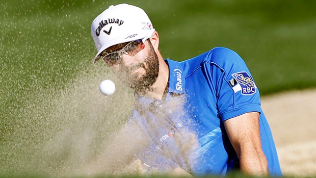 Adam Hadwin hits out of the bunker on the eighth fairway during the final round of the Career Builder Challenge golf tournament on the TPC Stadium course at PGA West in La Quinta Calif. on Sunday