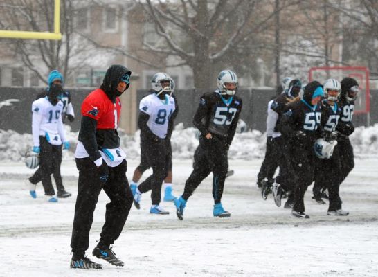 Carolina Panthers quarterback Cam Newton left walks across