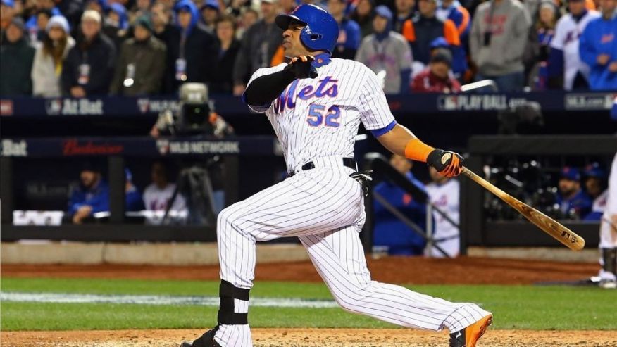 NEW YORK NY- OCTOBER 30 Yoenis Cespedes #52 of the New York Mets hits an sacrifice fly RBI in the sixth inning against Kelvin Herrera #40 of the Kansas City Royals during Game Three of the 2015 World Series at Citi Field