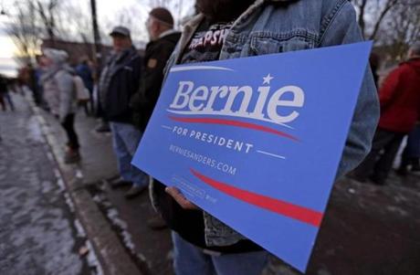 A Bernie Sanders supporter held a sign outside the Donald Trump campaign stop in Burlington Vt. on Thursday