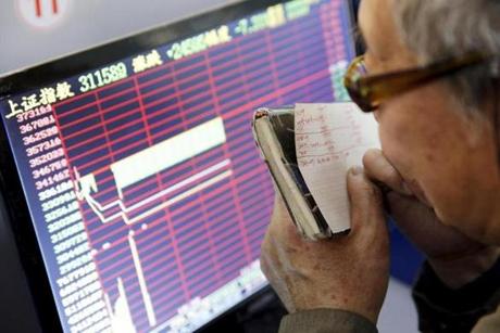 An investor looked at a screen showing stock information after China’s markets came to an abrupt halt Thursday