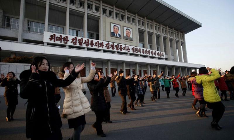 People dance near the Pyongyang Indoor Stadium in Pyongyang North Korea Friday Jan. 8 2016 after the government said it had conducted a hydrogen bomb test two days earlier