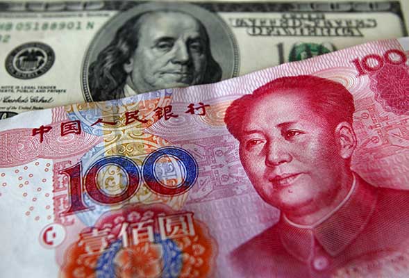 China's foreign reserves drop by record amid yuan support