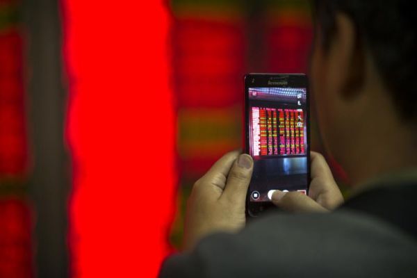 A Chinese investor takes a smartphone