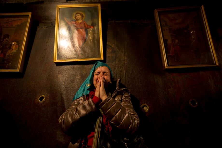 Christian pilgrims pray inside the Grotto of the Church of Nativity traditionally believed by Christians to be the birthplace of Jesus Christ in the West Bank town of Bethlehem on Christmas Eve