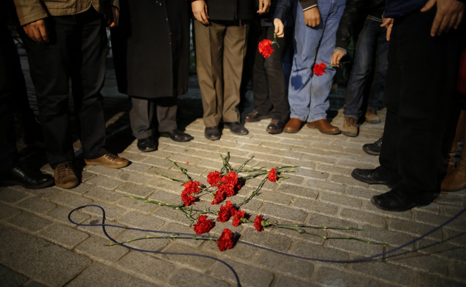 Citizens leave carnations as they gather near the site of the explosion in the historic Sultanahmet district in Istanbul