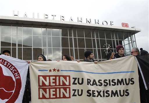 People protest in front of the main station in Cologne Germany on Wednesday Jan. 6 2016. The poster reads