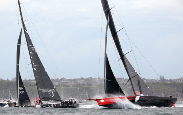 Comanche, of the U.S. races past Loyal of Australia shortly after the start of the annual Sydney Hobart yacht race in Sydney Saturday. The 628-nautical-mile race started in Sydney Harbour and is expected to end two to three days later in Hobart