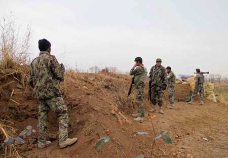 DESPERATE FIGHTING IN AFGHANISTAN Afghan National Army soldiers stand guard during an operation against Taliban militants in the Nad Ali district of Helmand on December 26. Afghan forces scrambled to beat back the Taliban from the city of Sangin