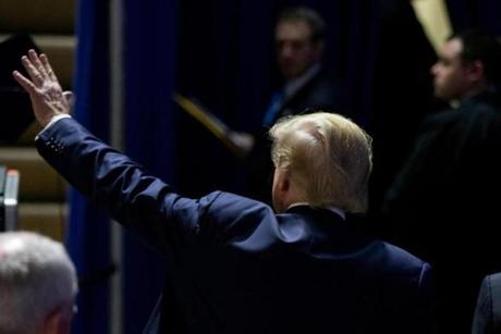 Republican presidential candidate Donald Trump wavesdto members of the audience as he departs after speaking at a rally at Muscatine High School in Iowa