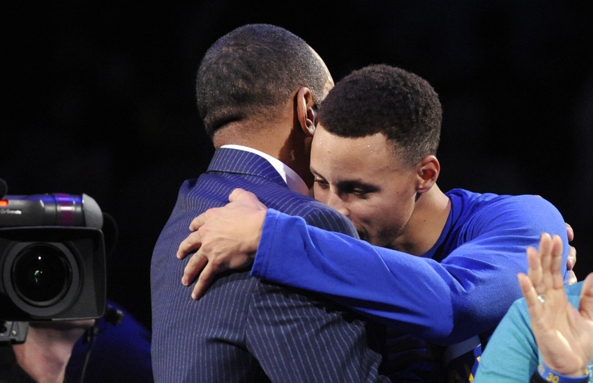 Dec 2 2015 Charlotte NC USA Charlotte Hornets former shooting guard Dell Curry gets a hug from his son Stephen Curry after being presented the key to Buzz City during a halftime ceremony at the game against the Golden State Warriors