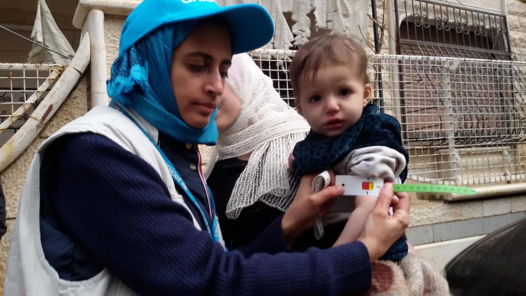 Dr. Rajia Sharhan UNICEF Nutrition Specialist takes a child's mid-upper arm circumference in Madaya Syria on Thursday. The city was under siege by government forces and didn't receive aid for months. Dozens of people have died of malnutritio