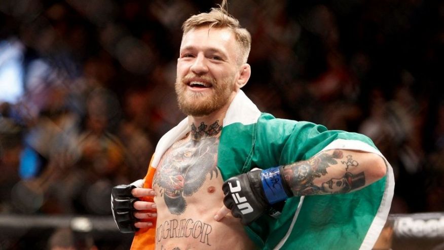 LAS VEGAS NV- DECEMBER 12 Conor Mc Gregor celebrates after a first-round knockout victory over Jose Aldo in their featherweight title fight during UFC 194