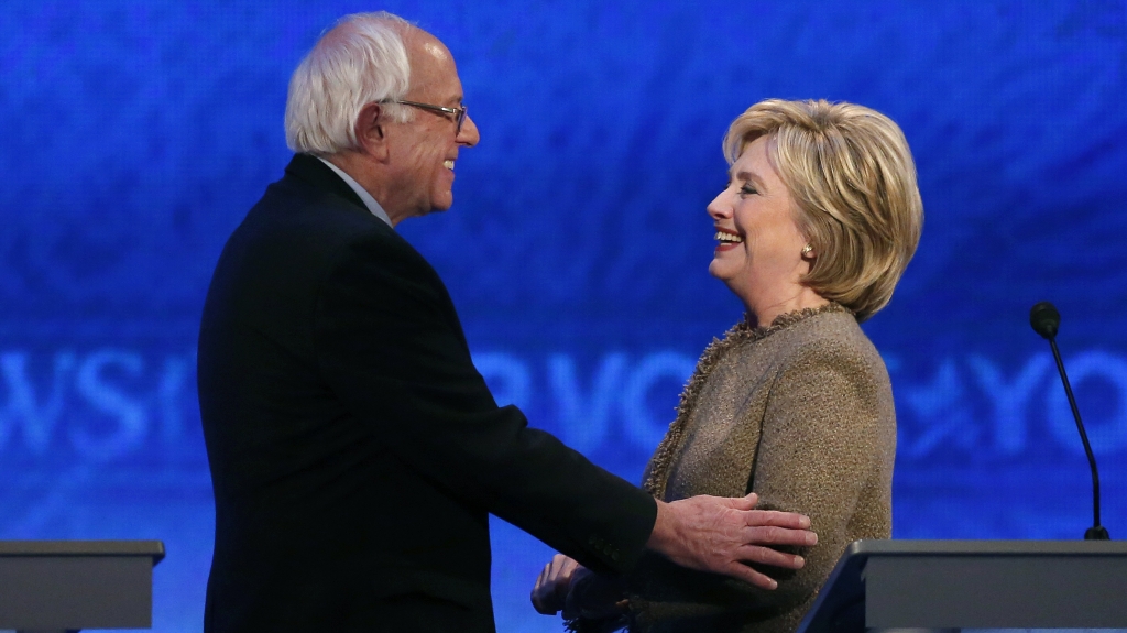 Bernie Sanders speaks with Hillary Clinton during a break at the third Democratic presidential debate Saturday night at Saint Anselm College in Manchester N.H