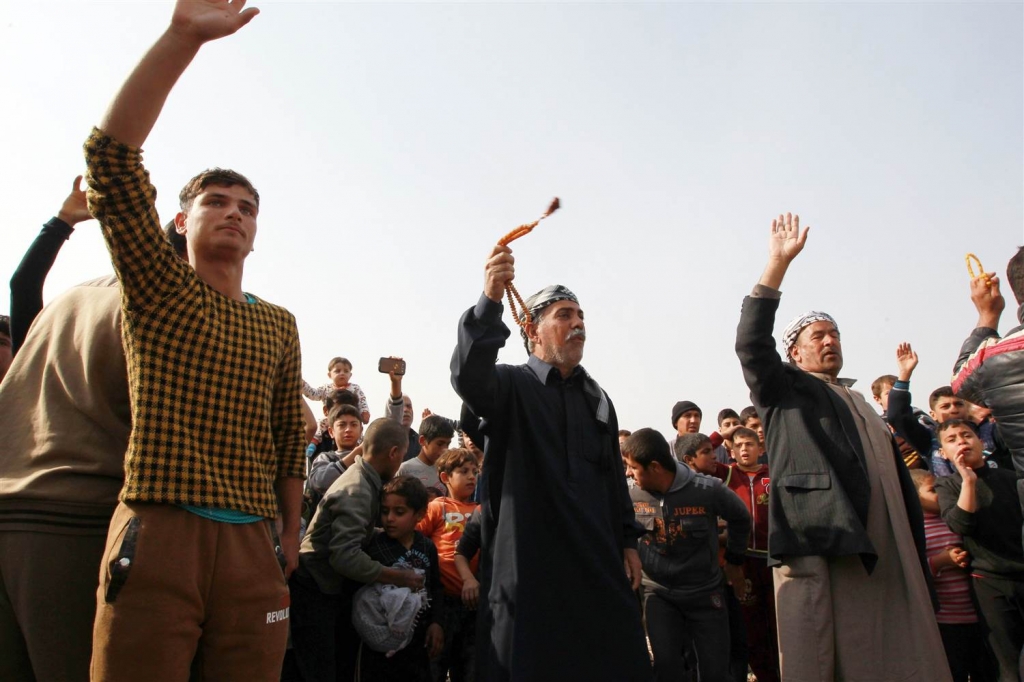 Image Displaced Ramadi residents celebrate Tuesday after their city was liberated from ISIS