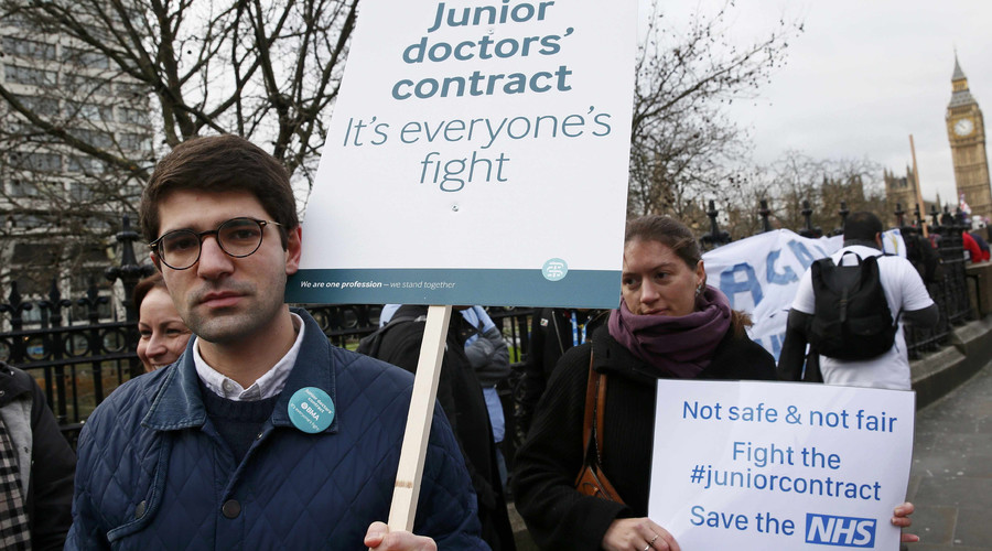 Doctors hold placards during a strike outside St Thomas&#039 hospital in central London Britain