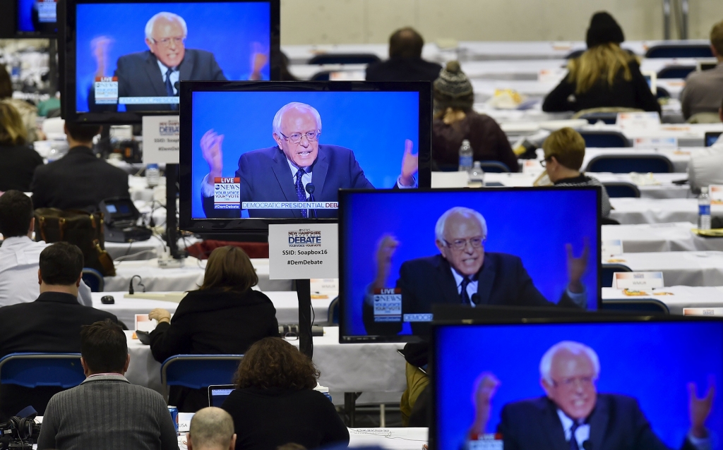 U.S. Democratic presidential candidate Bernie Sanders appears on television screens in the media work-room during the Democratic presidential candidates debate at Saint Anselm College in Manchester New Hampshire