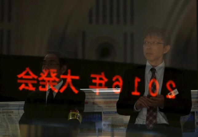 A visitor waits for the New Year opening ceremony at the Tokyo Stock Exchange, held to wish for the success of Japan's stock market in Tokyo Japan