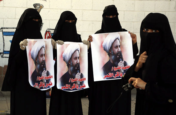 Supporters of Iran-allied Houthi movement hold posters of late Shiite cleric Nimr al-Nimr who was executed in Saudi Arabia