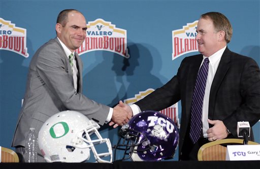 Oregon head coach Mark Helfrich left and TCU head coach Gary Patterson right shake hands following a news conference for the Alamo Bowl NCAA college football game Friday Jan. 1 2016 in San Antonio. The two teams meet on Saturday. (AP