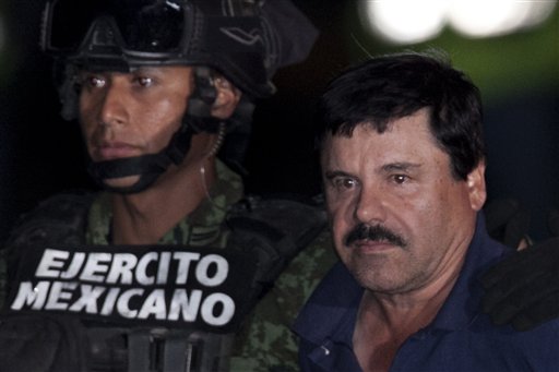 Mexican drug lord Joaquin'El Chapo Guzman right is escorted by soldiers and marines to a waiting helicopter at a federal hangar in Mexico City Friday Jan. 8 2016. The world's most wanted drug lord was recaptured by Mexican marines Friday six mont