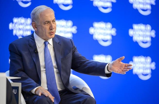 Israeli Prime Minister Benjamin Netanyahu gestires as he attends a conference at the World Economic Forum annual meeting in Davos