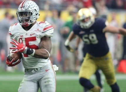 Ezekiel Elliott runs for one of his four TDs