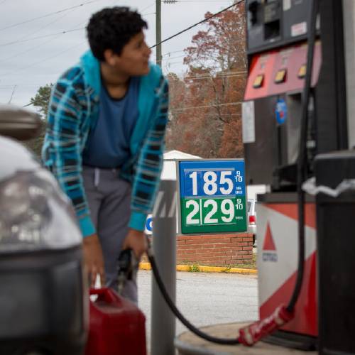 Cornelio Bonilla pumps gas at Best Food Mart gas station in Gainesville Ga. The price of oil continues to fall extending a slide that has already gone further and lasted longer than most thought and probi