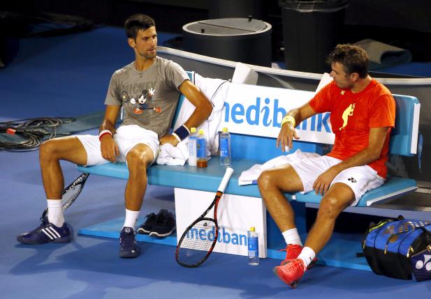 Serbia's Novak Djokovic talks with Switzerland's Stan Wawrinka as they take a break during a practice session at Melbourne Park Australia