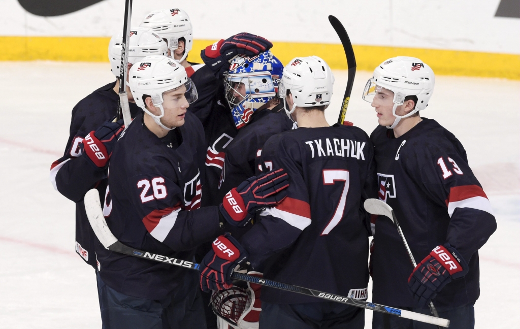 Members of the United States team celebrate after winning the bronze medal at the 2016 IIHF World Junior Ice Hockey Championship in Helsinki Finland on Jan. 5 2016. The Americans beat Sweden 8-3