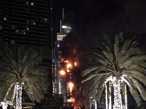 A fire runs up some 20 stories of a building in Dubai United Arab Emirates Thursday Dec. 31 2015. The fire broke out Thursday in a residential building near Dubai's massive New Year's Eve fireworks display. It was not immediately clear what