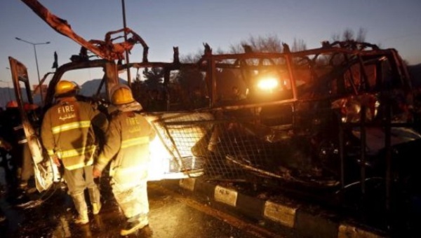 Fire-fighters inspect the wreckage of a bus was hit by a suicide bomb attack in Kabul Afghanistan Jan. 20 2016