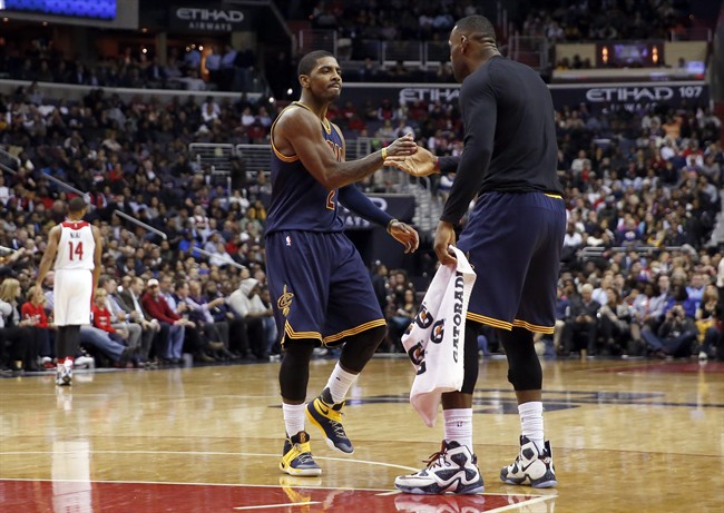 Cleveland Cavaliers guard Kyrie Irving and forward Le Bron James celebrate at the start of a timeout during the second half of the team's NBA basketball game against the Washington Wizards Wednesday Jan. 6 2016 in Washington. The Cavaliers won