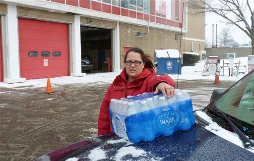 2016 Rabecka Cordell picks up a case of bottled water outside the fire station in Flint Mich. We both have lead poisoning, said Cordell who learned that two weeks ago from her doctor. She says she has leukemia and her son