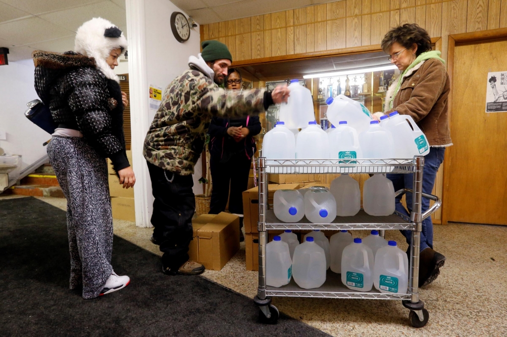 Flint residents receive free water being distributed at the Lincoln Park United Methodist Church in Flint Mich