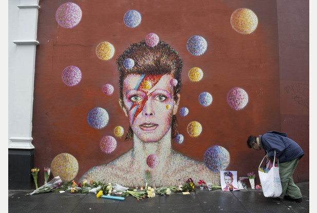 Flowers left on Bowie mural in London       	      	     VIEW