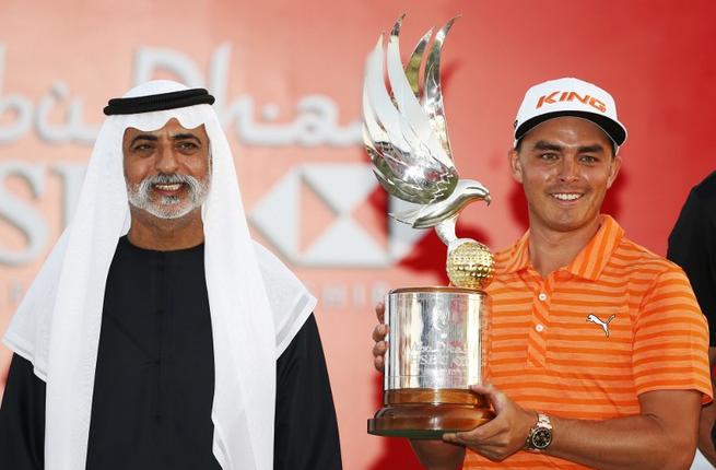 Rickie Fowler of the United States celebrates with his trophy after winning in the final of the Abu Dhabi Golf Championship in the capital of the United Arab Emirates