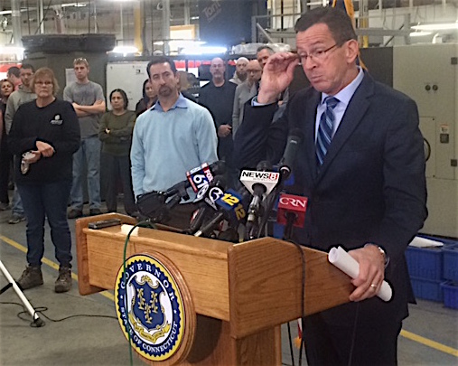 Gov. Dannel P. Malloy takes questions about GE at a hastily arranged appearance at Pegasus Manufacturing. At left is the company president Chris DiPentima