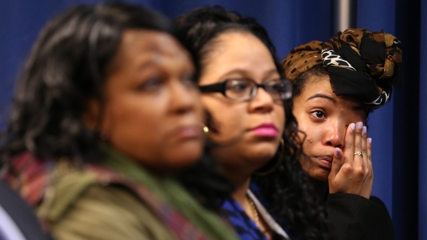 Bridget Anderson right wipes away a tear as De Kalb County District Attorney Robert James announces Thursday that a grand jury indicted De Kalb County Police Officer Robert Olsen for shooting and killing of her boyfriend Anthony Hill