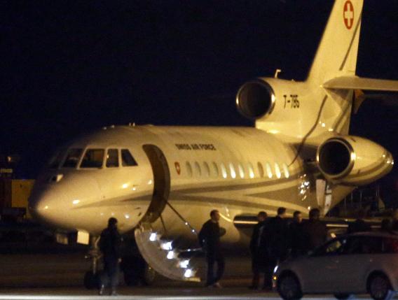 People walk off a plane carrying three Iranian-Americans who left Tehran under a prisoner swap after it landed at Cointrin airport in Geneva Switzerland