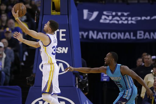 Golden State Warriors guard Klay Thompson right celebrates a basket as guard Ian Clark watches uring the first half of an NBA basketball game against the L