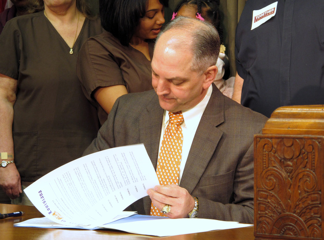 Louisiana Gov. John Bel Edwards signs an executive order on his first full day in office starting the process for expanding Louisiana's Medicaid program