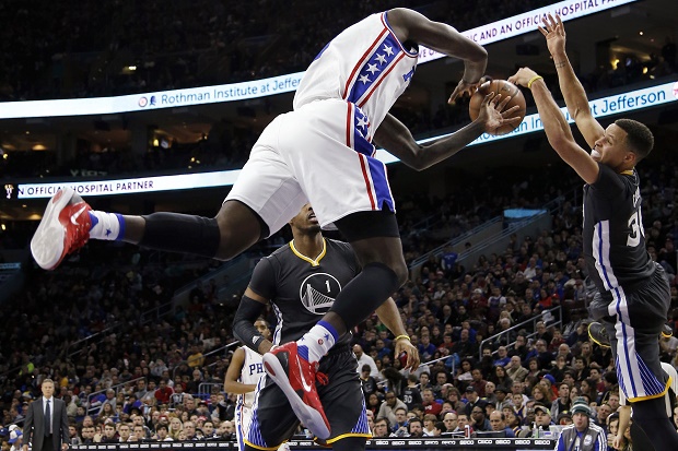 Golden State Warriors Stephen Curry right blocks a shot by Philadelphia 76ers Ja Karr Sampson during the second half of an NBA basketball game Saturday Jan. 30 2016 in Philadelphia. Golden State won 108-105