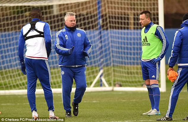 Guus Hiddink instructs his Chelsea players in training on Friday alongside captain John Terry