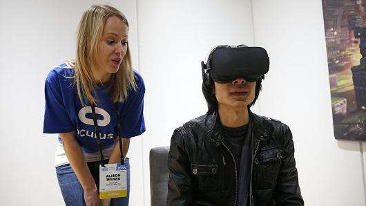 Alison Weber left instructs Peijun Guo on using the Oculus Rift VR headset at the Oculus booth at CES International Wednesday Jan. 6 2016 in Las Vegas