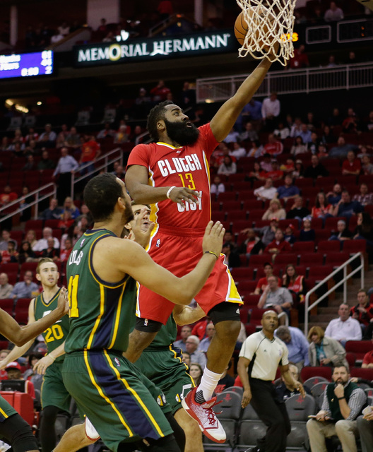 ASSOCIATED PRESS           Houston Rockets guard James Harden drives past Utah Jazz forward Trey Lyles for a layup during the first half of an NBA basketball game Thursday Jan. 7 2016 in Houston